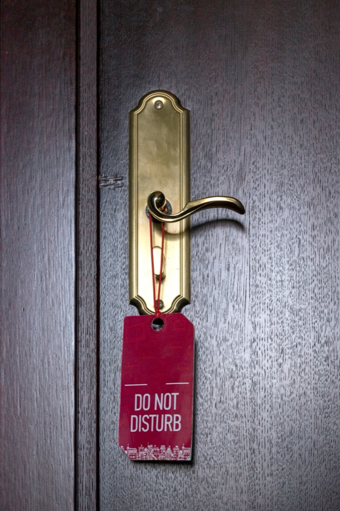 A red door hanger on a brass door handle